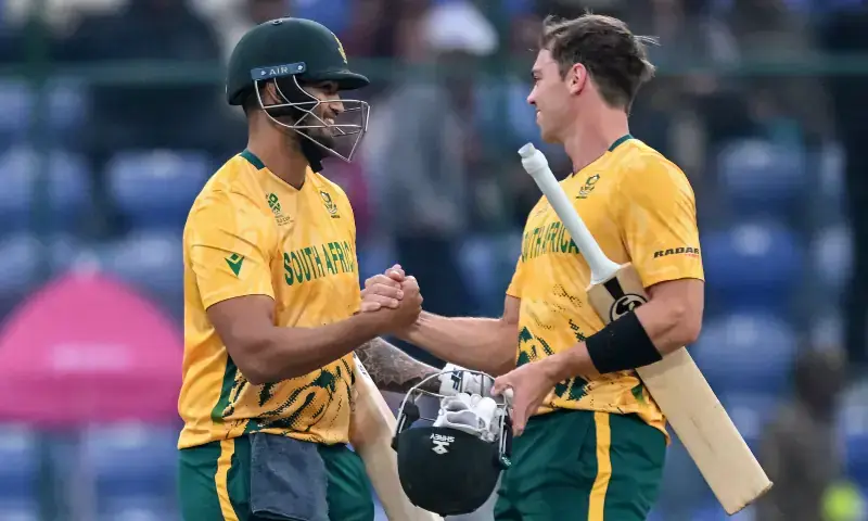 South Africa&rsquo;s Jason Smith (L) and Tristan Stubbs celebrate their team&rsquo;s win at the end of the 2026 ICC Men&rsquo;s T20 Cricket World Cup group stage match between South Africa and United Arab Emirates at the Arun Jaitley Stadium in New Delhi on February 18, 2026. &mdash; AFP