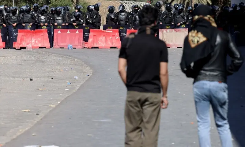 Iraqis security forces watch as protesters try to approach a bridge leading to the Green Zone where the US embassy is located, in Baghdad on March 1, 2026. &mdash;AFP