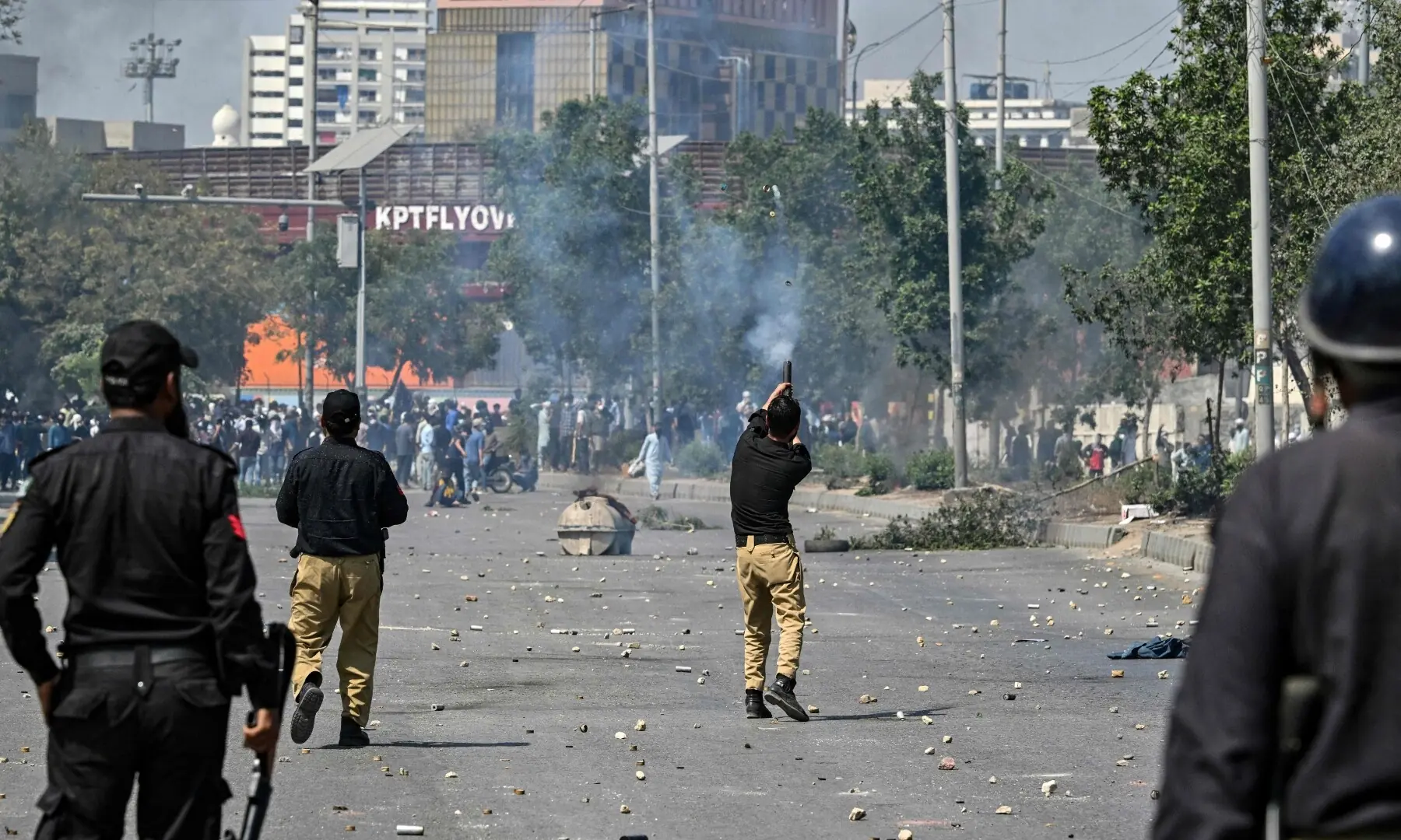 Security personnel fire tear gas as protesters shout slogans during a protest outside the US consulate in Karachi on March 1, 2026. &mdash; AFP