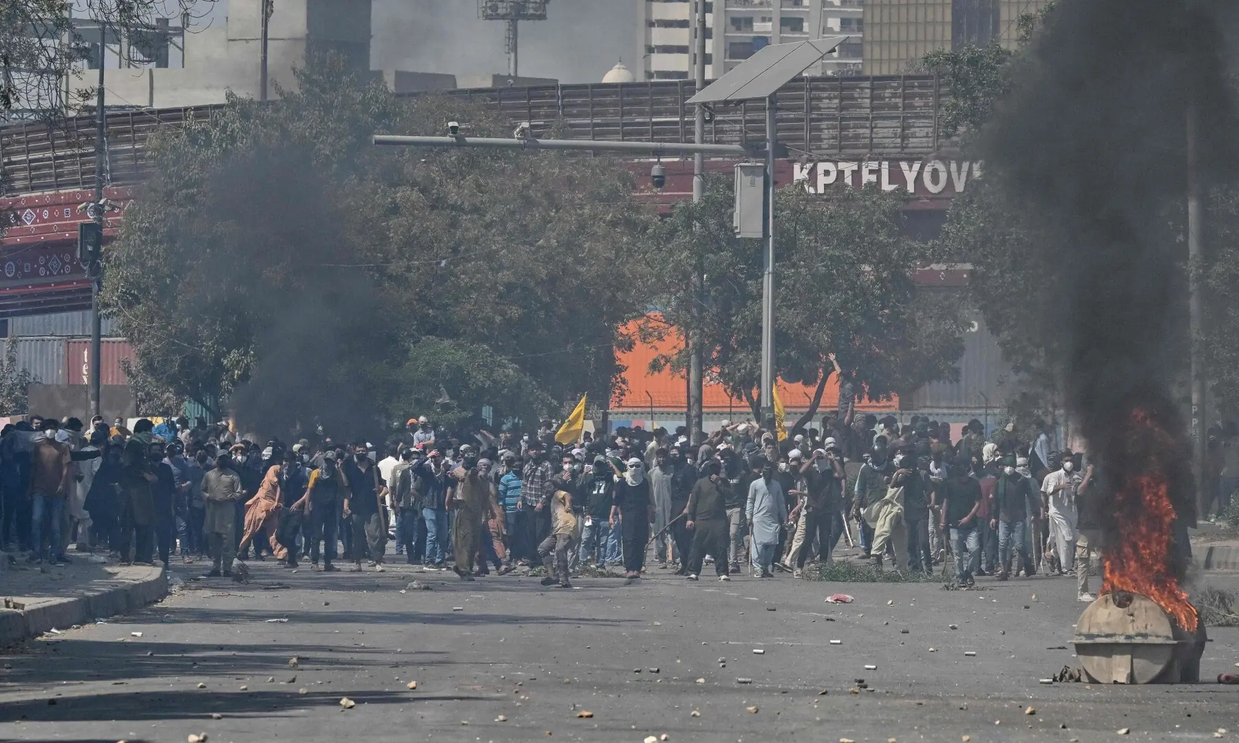 Protesters throw stones at riot police during a protest outside the US consulate in Karachi on March 1, 2026. &mdash; AFP