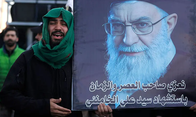 An Iraqi Shia man holds a large image of of dead Iranian supreme leader Ayatollah Ali Khamenei as he grieves in Baghdad, Iraq on March 1. &mdash; AFP