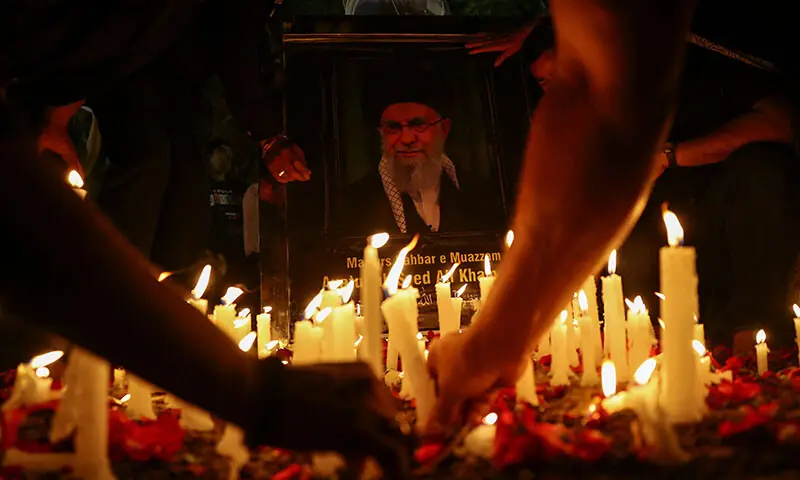 Shia Muslims place candles in front of a photo of Iran&rsquo;s supreme leader Ayatollah Ali Khamenei during a candle march and protest near a mosque in New Delhi, India, on March 1, after he was killed in Israeli and US strikes. &mdash; Reuters