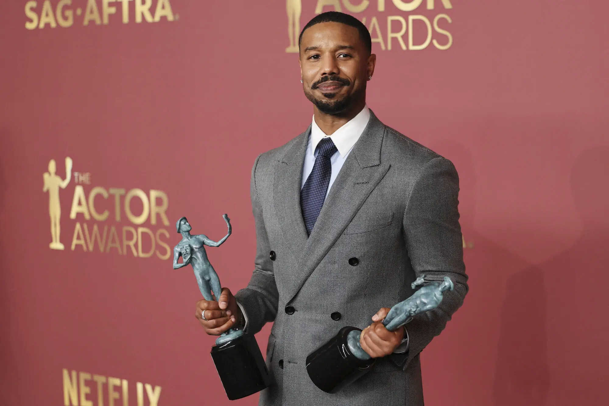 Michael B Jordan poses with the awards for Best Male Actor in a Leading Role and Best Cast in a Motion Picture. Photo: Reuters