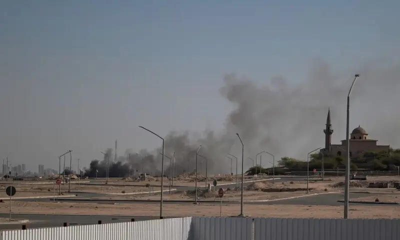 Smoke rises from a reported Iranian strike in the area where the US Embassy is located in Kuwait City on Monday.  &mdash;AFP