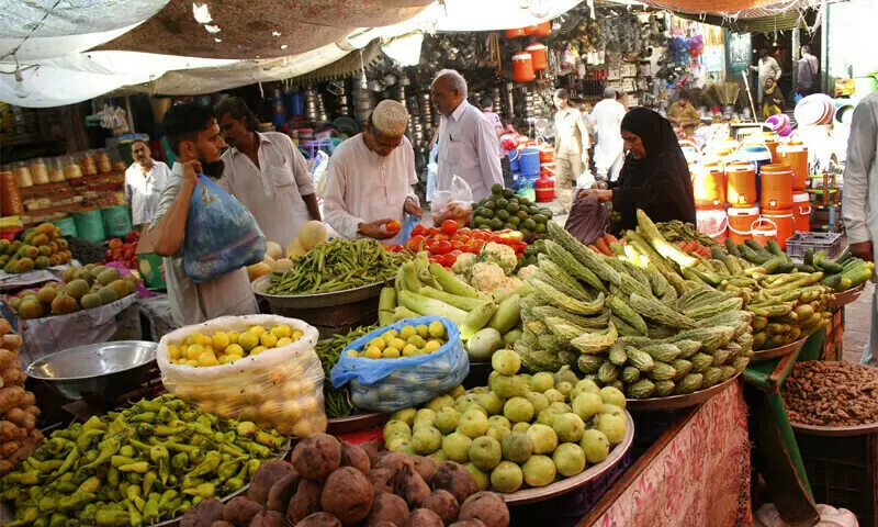 In this file photo, people buy vegetables from Karachi&rsquo;s Empress Market. &mdash; Photo by Shahab Nafees/File