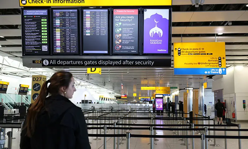 A traveller checks on a departure board displaying cancelled flights to Middle Eastern countries amid the US-Israel conflict with Iran, at Heathrow Airport Terminal 4, in London, the UK on March 2. &mdash; Reuters