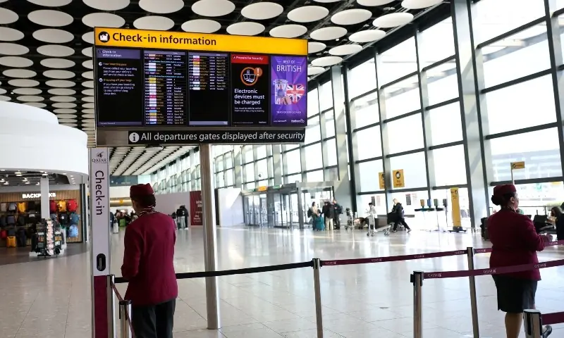 Qatar airline staff stand by a departure board displaying cancelled flights to Middle East countries amid the US-Israel conflict with Iran, at Heathrow Airport Terminal 4, in Greater London, Britain, March 2, 2026. &mdash;Reuters