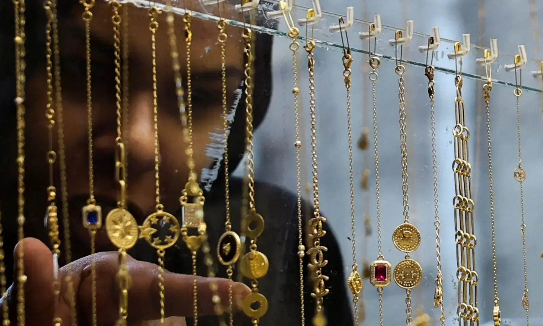 An Egyptian woman looks at gold jewelry in Cairo, Egypt, February 5, 2026 &mdash; Reuters/File