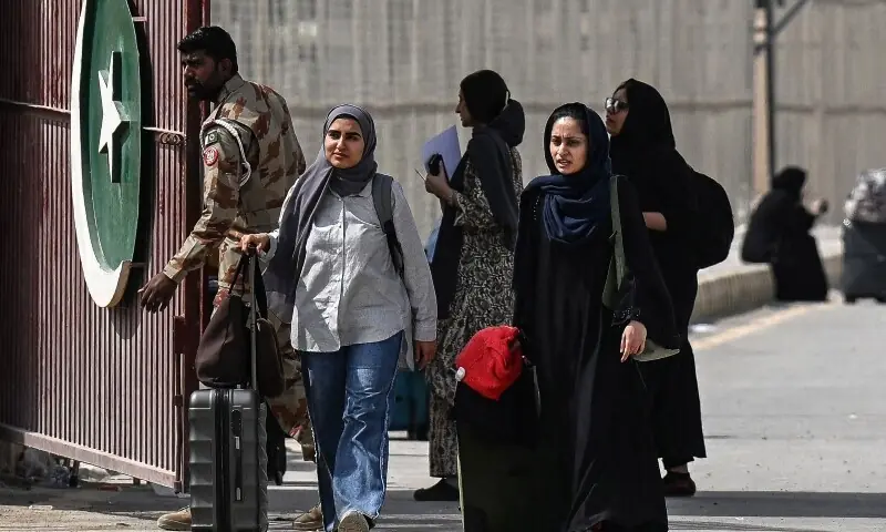 Pakistani nationals walk across the Taftan border after returning from Iran, in Balochistan province, on March 2, 2026 amid ongoing US-Israel strikes on Iran. &mdash;AFP/File