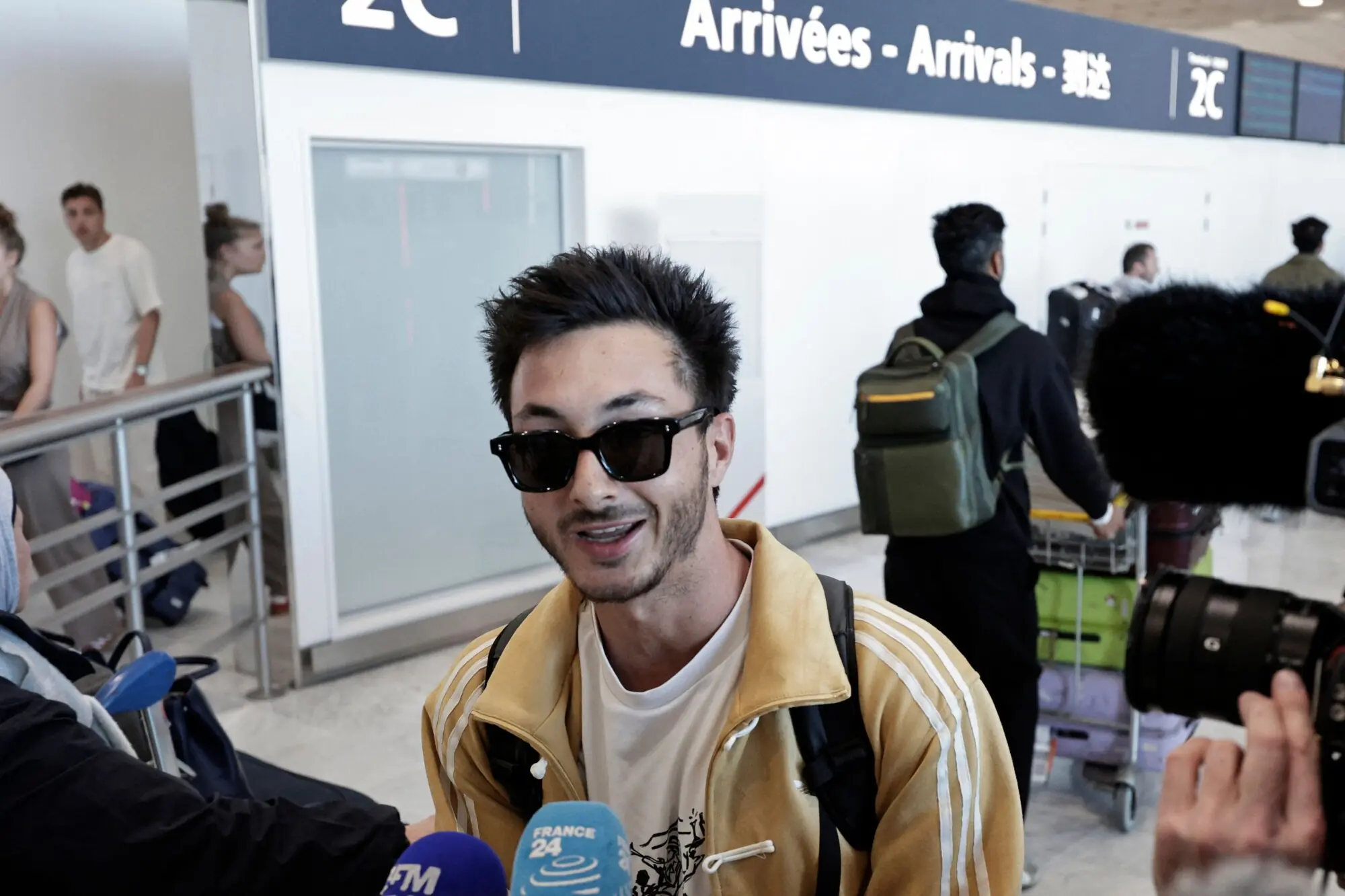 A passenger speaks to the press after disembarking from a flight coming from Dubai at Roissy-Charles de Gaulle Airport on the outskirts of Paris, France on March 3. &mdash; AFP