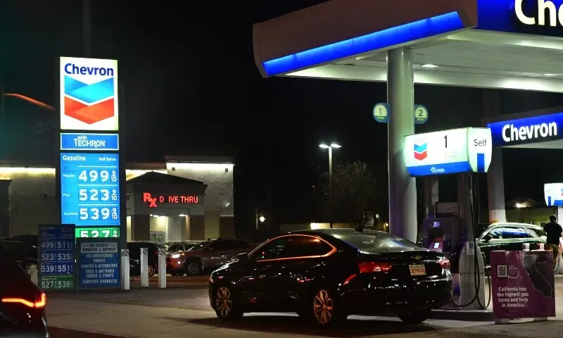 A sign with current gas prices is displayed at a gas station in Los Angeles, California on March 2, 2026. &mdash; AFP