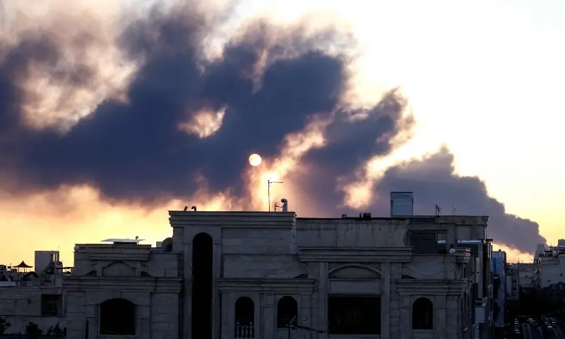 The sun is seen through a plume of black smoke following a strike on Tehran, Iran on March 3. &mdash; AFP