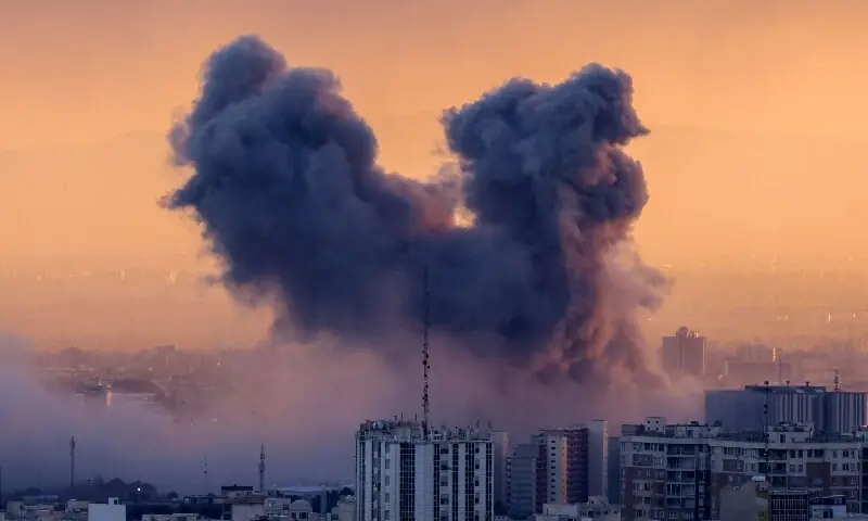 A plume of smoke rises after a strike on Tehran, Iran on March 3. &mdash; AFP
