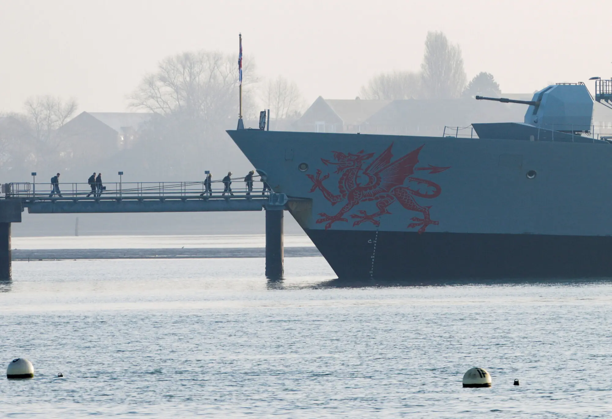 Crew members stand aboard the HMS Dragon during ammunitioning operations at Upper Harbour Ammunitioning Facility (UHAF) in Portsmouth Harbour,in Portsmouth, Britain, March 4, 2026. &mdash;Reuters