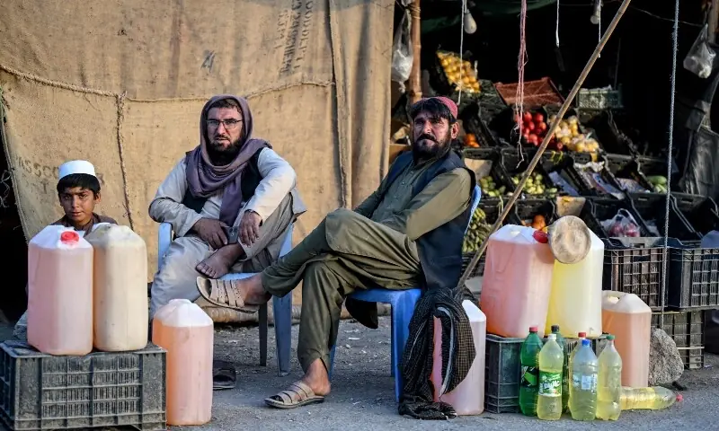 Pakistani vendors selling petrol wait for customers at their stall in Taftan, Balochistan province on March 4. &mdash; AFP