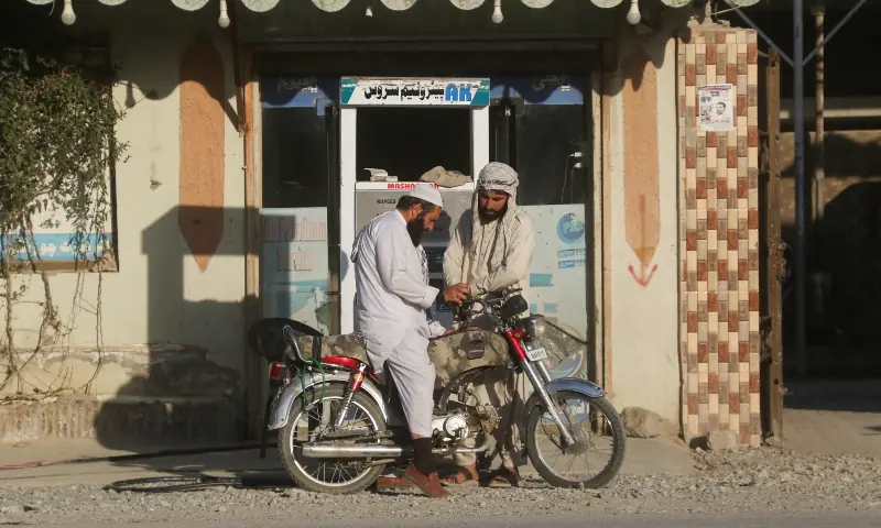 A man on a motorcycle gets his bike refuelled with petrol, brought from Iran, amid the US-Israel conflict with Iran, at a shop in Quetta on March 4, 2026. &mdash; Reuters