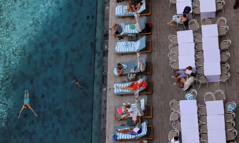 People swim and rest at Vida Creek Harbour hotel amid the US-Israeli conflict with Iran, in Dubai, United Arab Emirates on March 4, 2026. &mdash; Reuters