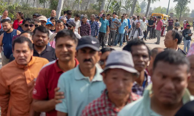 People stand in a queue outside a polling station as they wait for their turn to vote at a village, in Jhapa district, Nepal on March 5, 2026. &mdash; Reuters