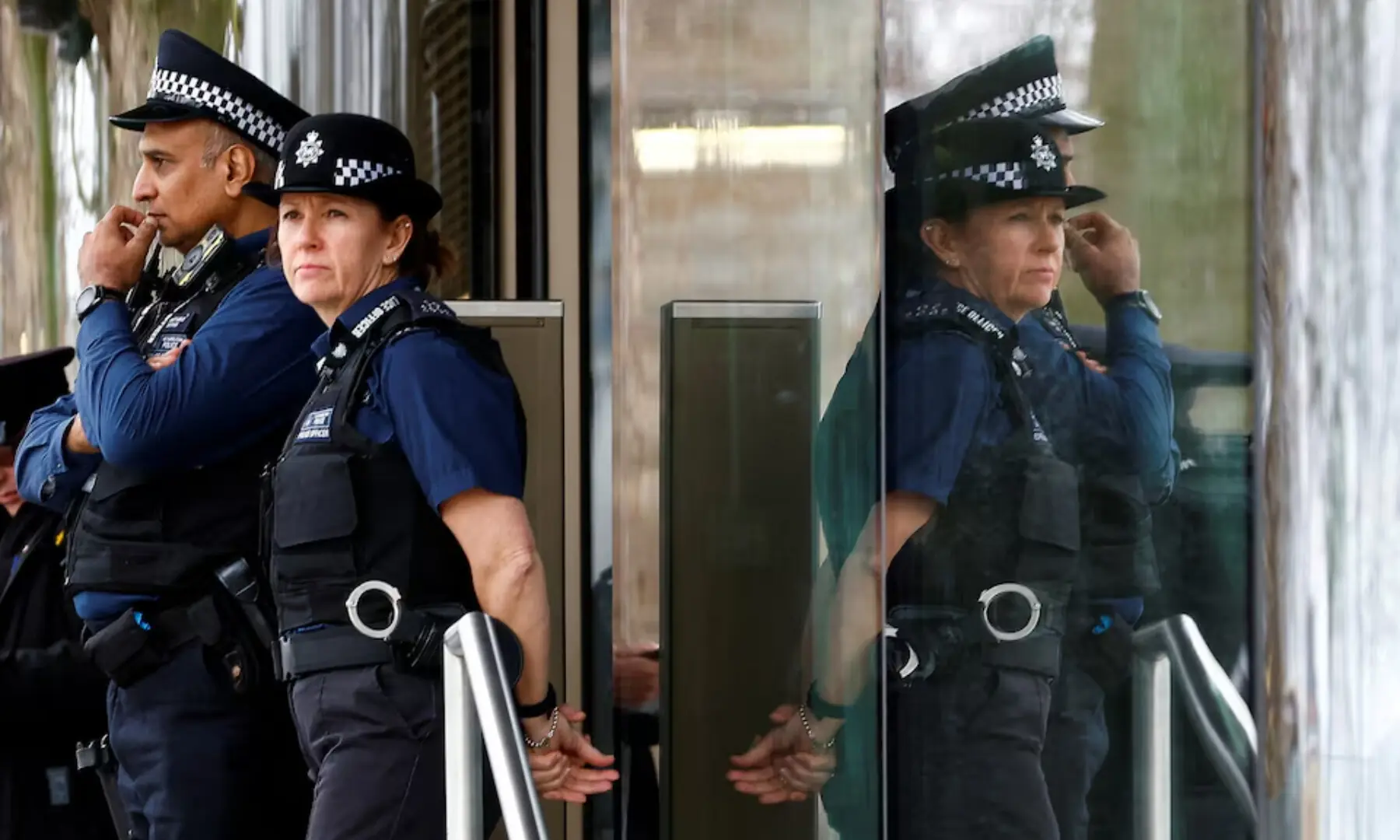 Police officers stand outside New Scotland Yard, the headquarters of the Metropolitan Police, in London. &mdash; Reuters/File