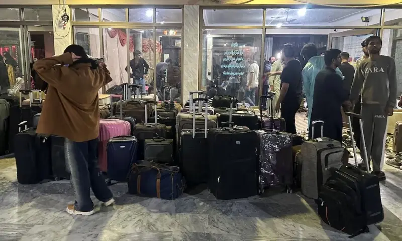 Pakistani students stand next to their luggage after their reutrn from Iran in Quetta on March 4. &mdash; Reuters