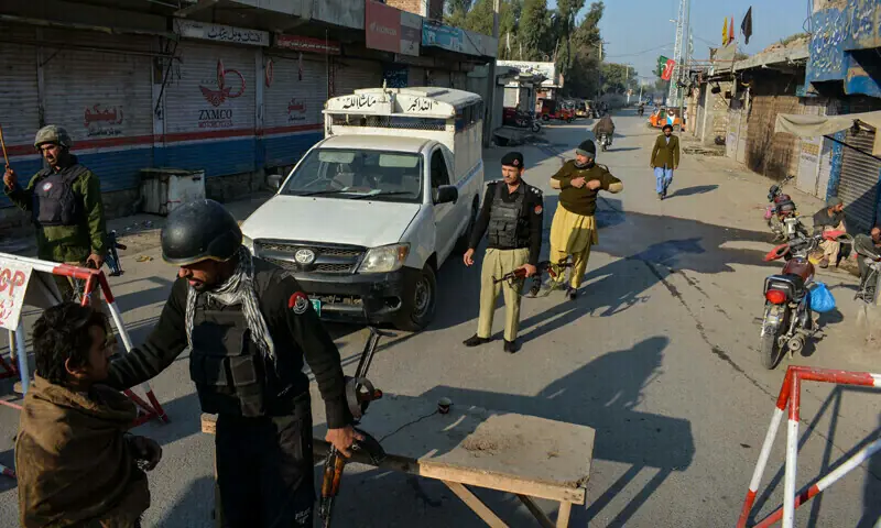 Police stand guard along a road they blocked after militants seized a police station in Bannu on December 19, 2022. &mdash; AFP/File