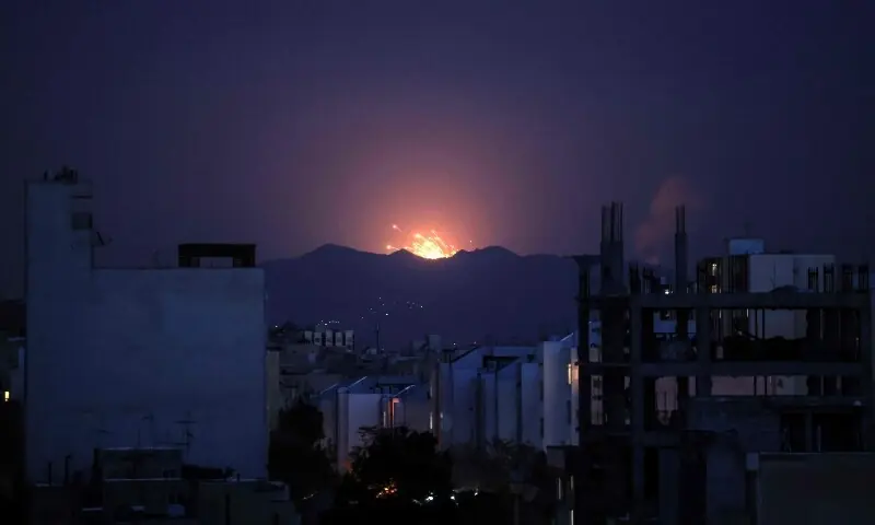 The sky is lit up at the site of an airstrike in a central area of Tehran, Iran on March 6. &mdash; AFP