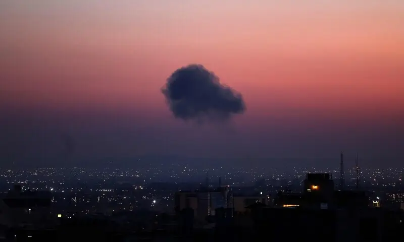 A black plume of smoke ascends from the site of an airstrike in a central area of Tehran, Iran on March 6. &mdash; AFP