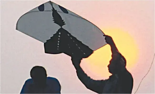 A picture shows a man preparing kite-flying. &mdash; AFP/file