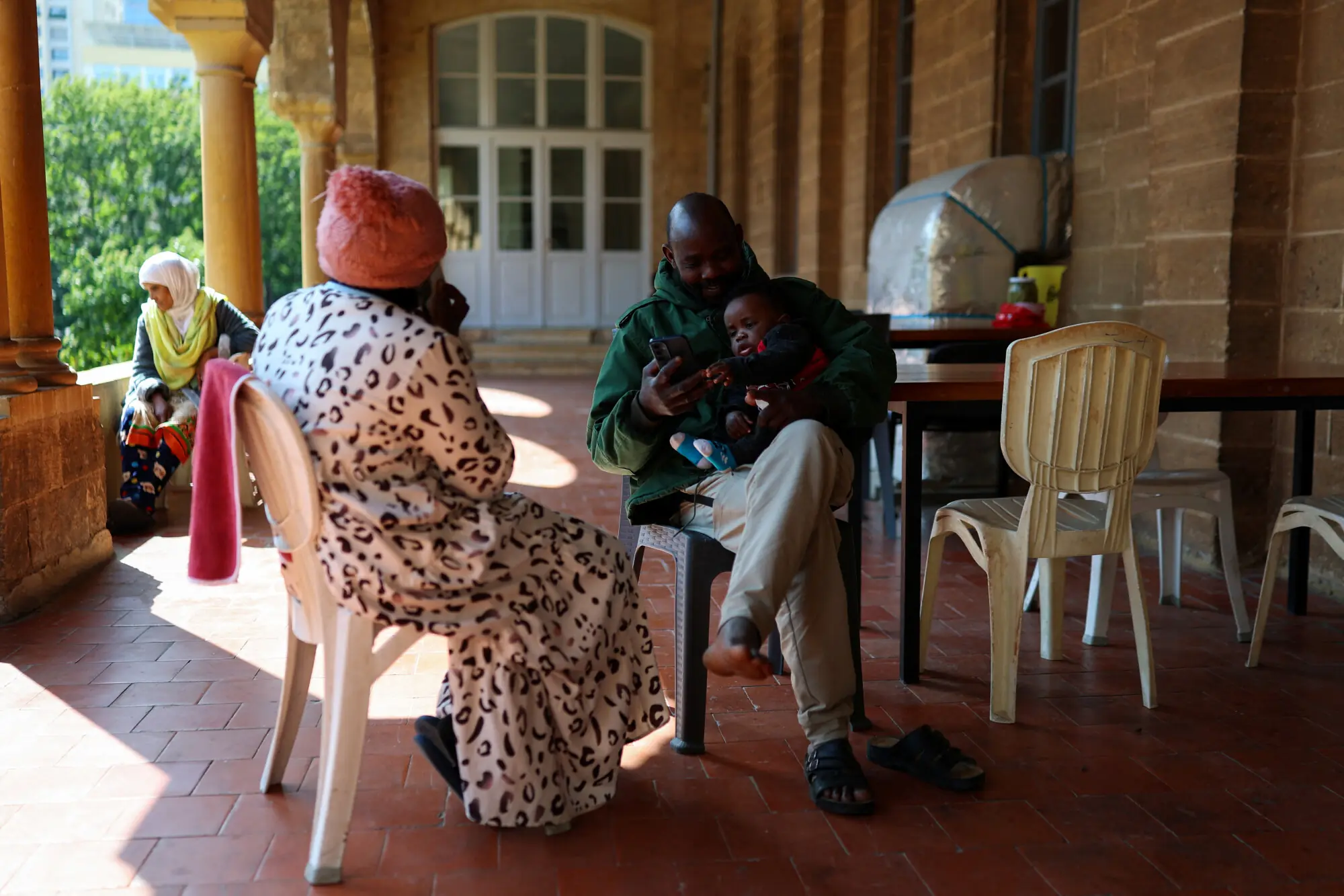 Othman Yahyeh Dawood, 41, with his son Mohammed, 10 months, from Sennar, Sudan, sits as refugees and displaced migrant workers shelter in St. Joseph Church, following an escalation between Hezbollah and Israel amid the US-Israeli conflict with Iran, in Beirut, Lebanon, March 6, 2026. &mdash;Reuters