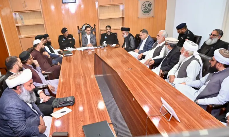 Flanked by district police chief and other officials, deputy commissioner Muzaffarabad Munir Ahmed Qureshi presides over the district peace committee meeting in Muzaffarabad on Mar 6. &mdash; photo via author