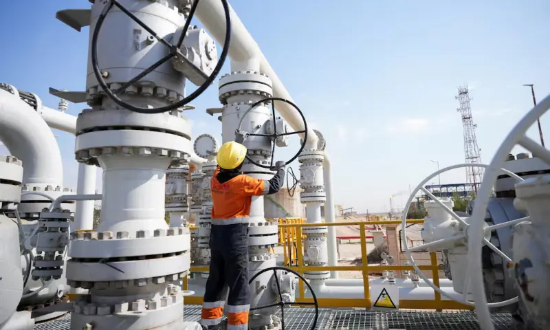 A worker operates valves at the Rumaila oil field, as the country cuts nearly 1.5 million barrels per day of output amid halted exports following the closure of the Strait of Hormuz, in Basra, Iraq on March 4, 2026. &mdash; Reuters