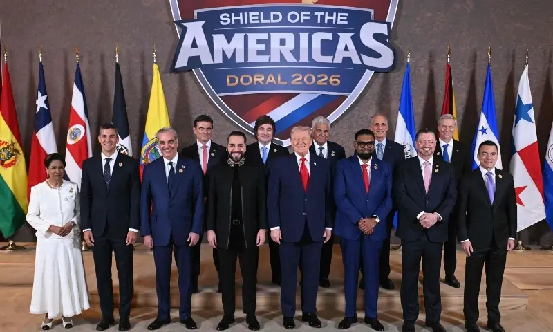 US President Donald Trump (C) stands with the leaders of Latina America and Carribea, during a group photograph at the start of the Shield of the Americas Summit at Trump National Doral in Miami, Florida on March 7, 2026. &mdash; AFP