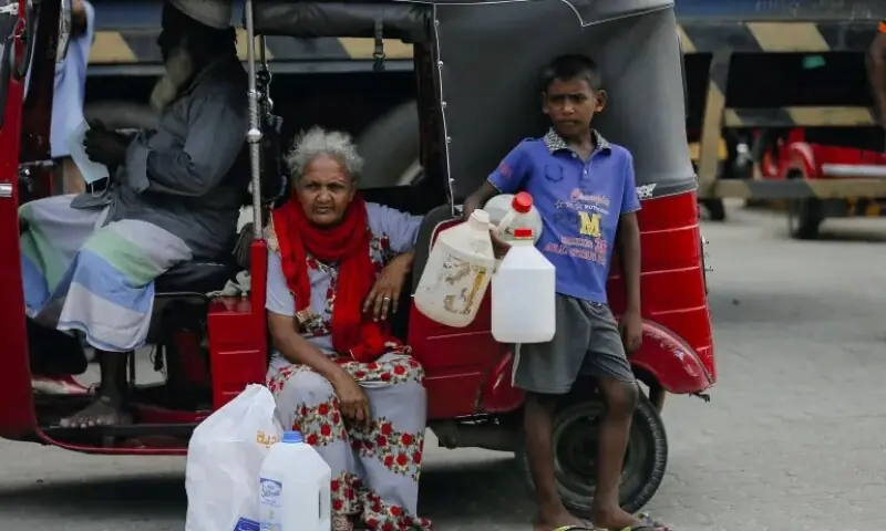 A family waits to buy kerosene amid a shortage of domestic gas, at a fuel station in Colombo. Photo for representation only. &mdash; Reuters