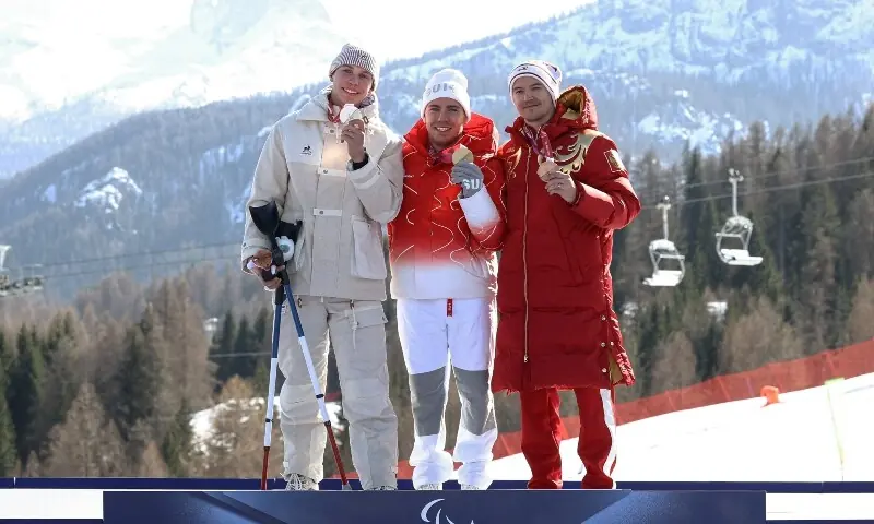 Gold medalist Robin Cuche of Switzerland celebrates on the podium during the men&rsquo;s downhill standing victory ceremony with silver medalist Arthur Bauchet of France and bronze medalist Aleksei Bugaev of Russia. &mdash; Reuters