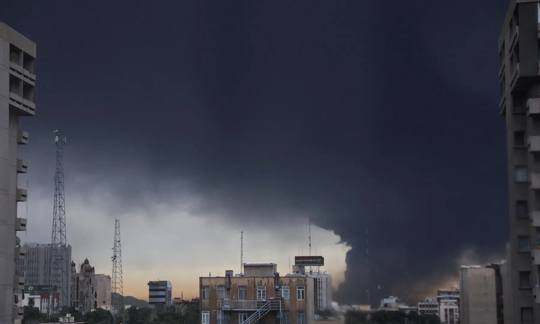 Smoke rises after a reported strike on fuel tanks at an oil refinery in Tehran, Iran on March 8, 2026. &mdash; WANA via Reuters