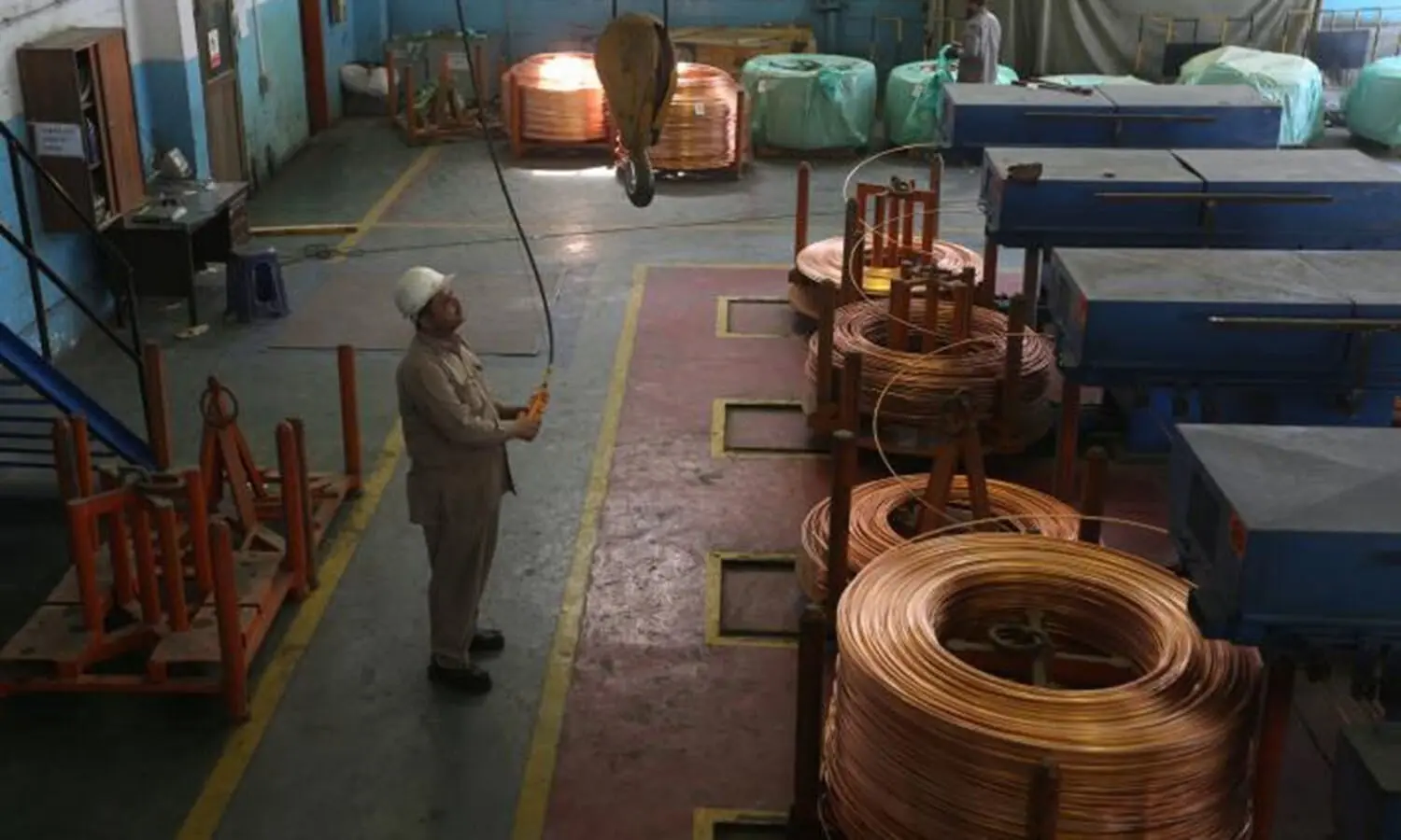 A worker operates a crane at a copper wire unit at Pakistan Cables in Karachi. ─ Reuters/File