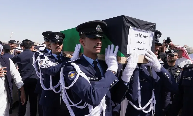 Guards of Honour carry the coffin of one of two police officers, who were killed while performing their duties, during their funeral procession at a graveyard in Kuwait City, Kuwait, March 9. &mdash; Reuters