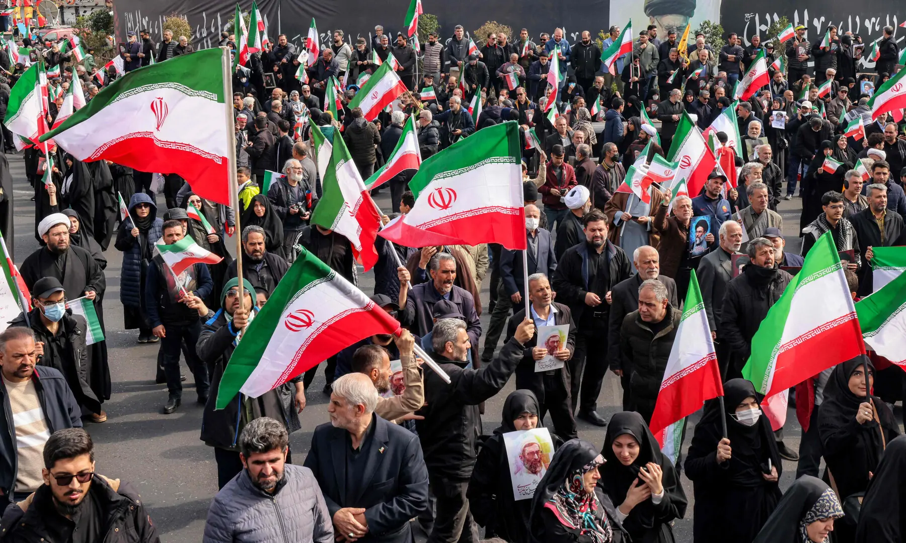 Demonstrators gather with Iranian national flags for a rally in support of the new Supreme Leader at Enghelab Square in central Tehran on March 9, 2026. &mdash; AFP