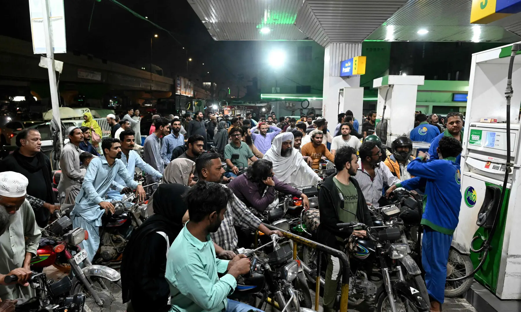 Clients queue at a gas station amid rising petrol prices in Karachi on March 7, 2026. &mdash; AFP