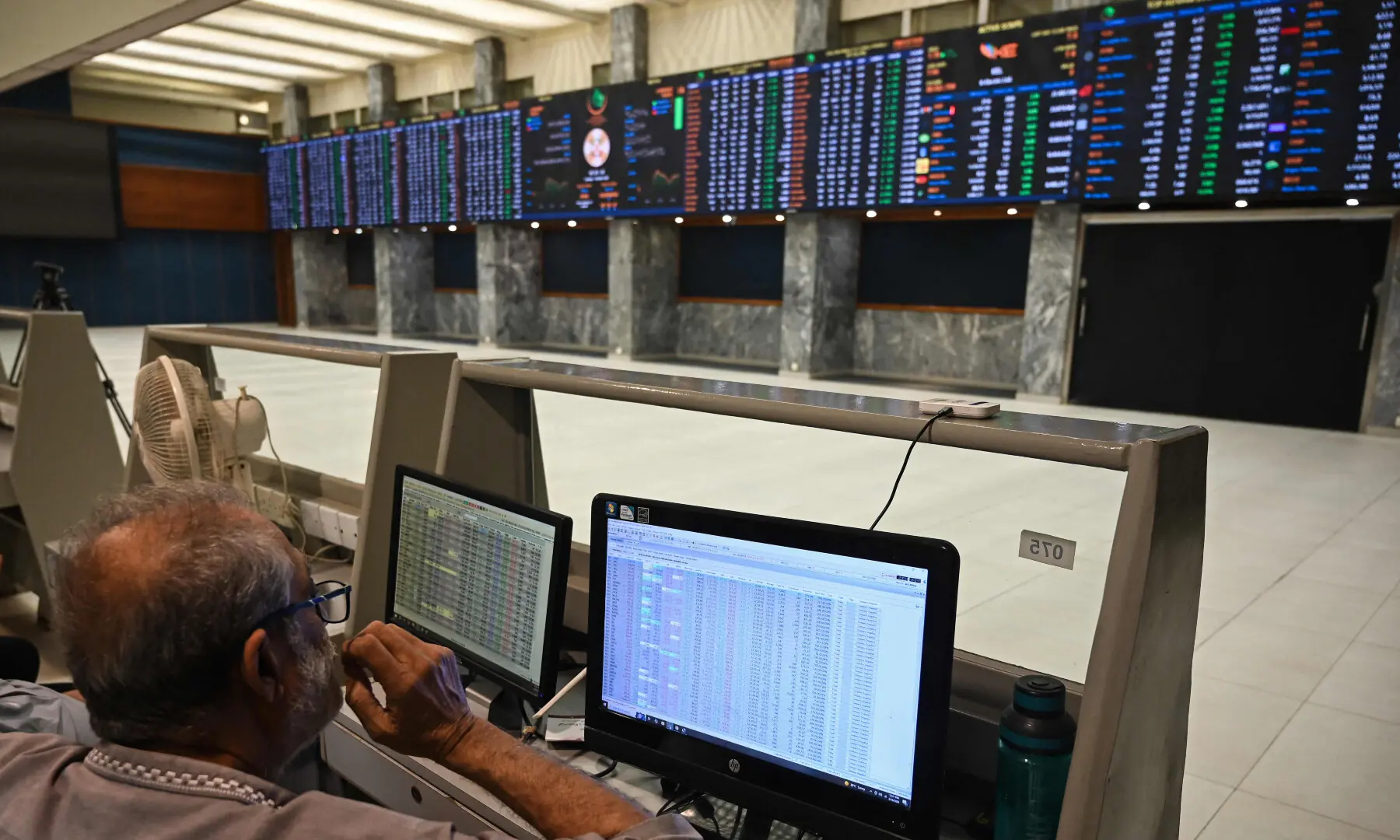 A stock broker works during a trading session at the Pakistan Stock Exchange (PSX) in Karachi on March 10, 2026. &mdash; AFP
