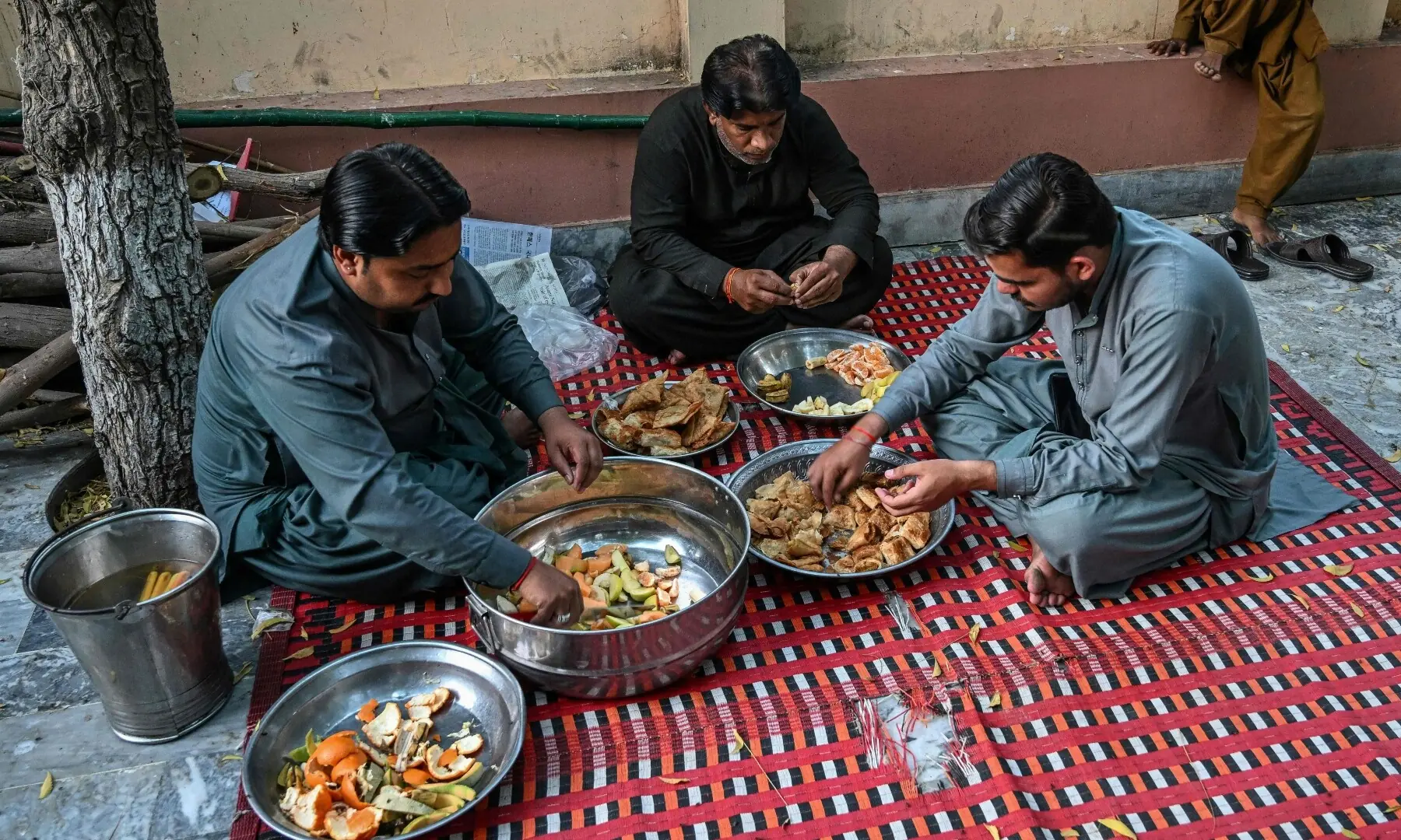 This photograph taken on February 26, 2026 shows Hindu men preparing Iftar meals during Ramazan, inside a Sufi shrine at Mithi in the Tharparkar district of Sindh. &mdash; AFP