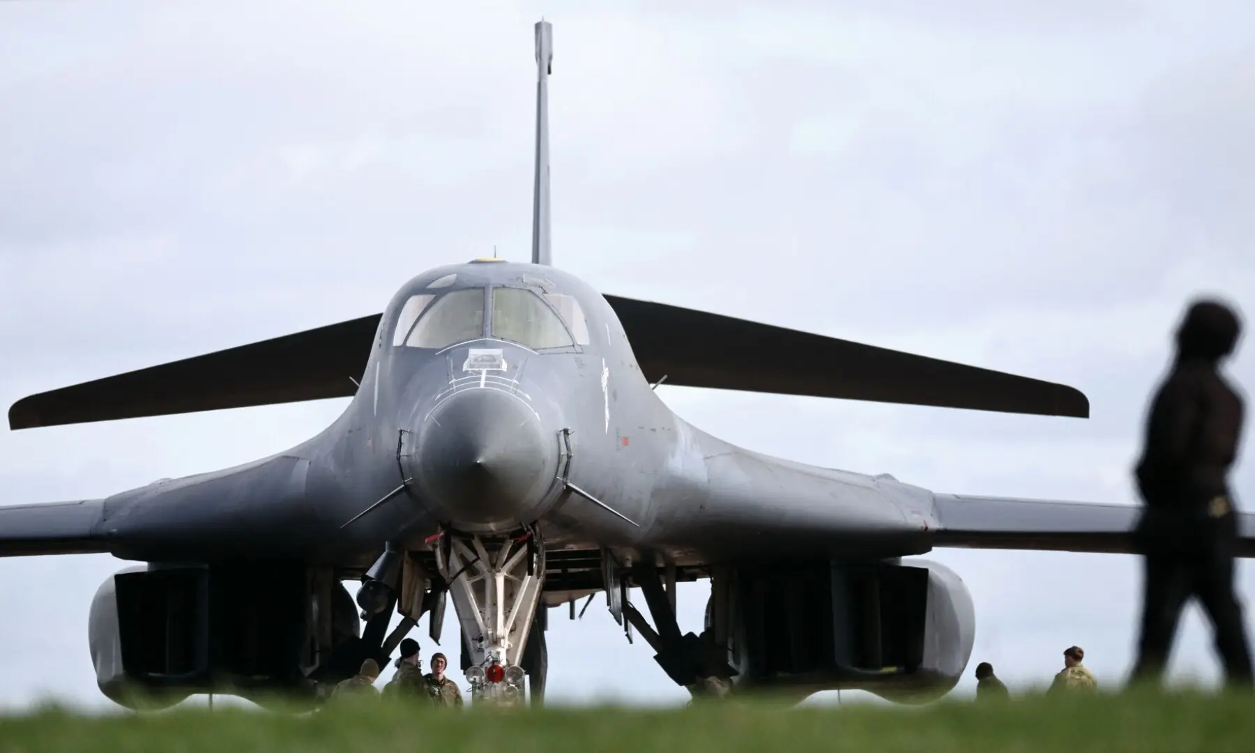 US Air Force (USAF) personnel work on a USAF B-1 Lancer bomber parked on the tarmac at RAF Fairford in south-west England on March 10. &mdash; AFP