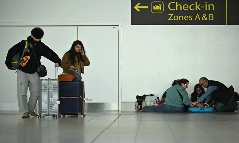 Passengers wait inside a terminal at London&rsquo;s Gatwick airport amid flight cancellations following the US and Israeli strikes on Iran.&mdash;AFP