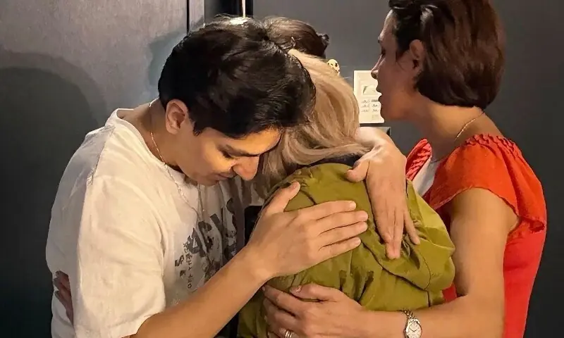This undated photo released by Australia&rsquo;s Department of Home Affairs on March 11, 2026 shows an Iranian football team official (C) reuniting with player Zahra Ghanbari (L) in Sydney. &mdash;AFP