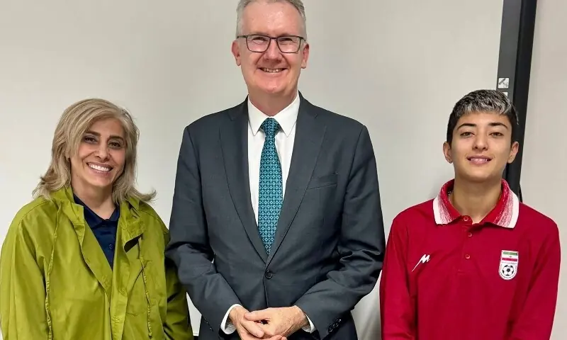An undated photo released by Australia&rsquo;s Department of Home Affairs on March 11, 2026 shows Australia&rsquo;s Home Affairs Minister Tony Burke (C) with an Iranian football player (R) and team official (L) in Sydney, after they claimed asylum in Australia. &mdash;AFP