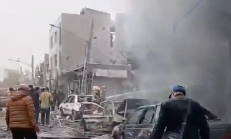 People gather near damaged vehicles following a reported strike, amid the US-Israeli conflict with Iran, in Tehran, Iran, in this screen grab obtained from social media video released March 11, 2026. &mdash; Reuters