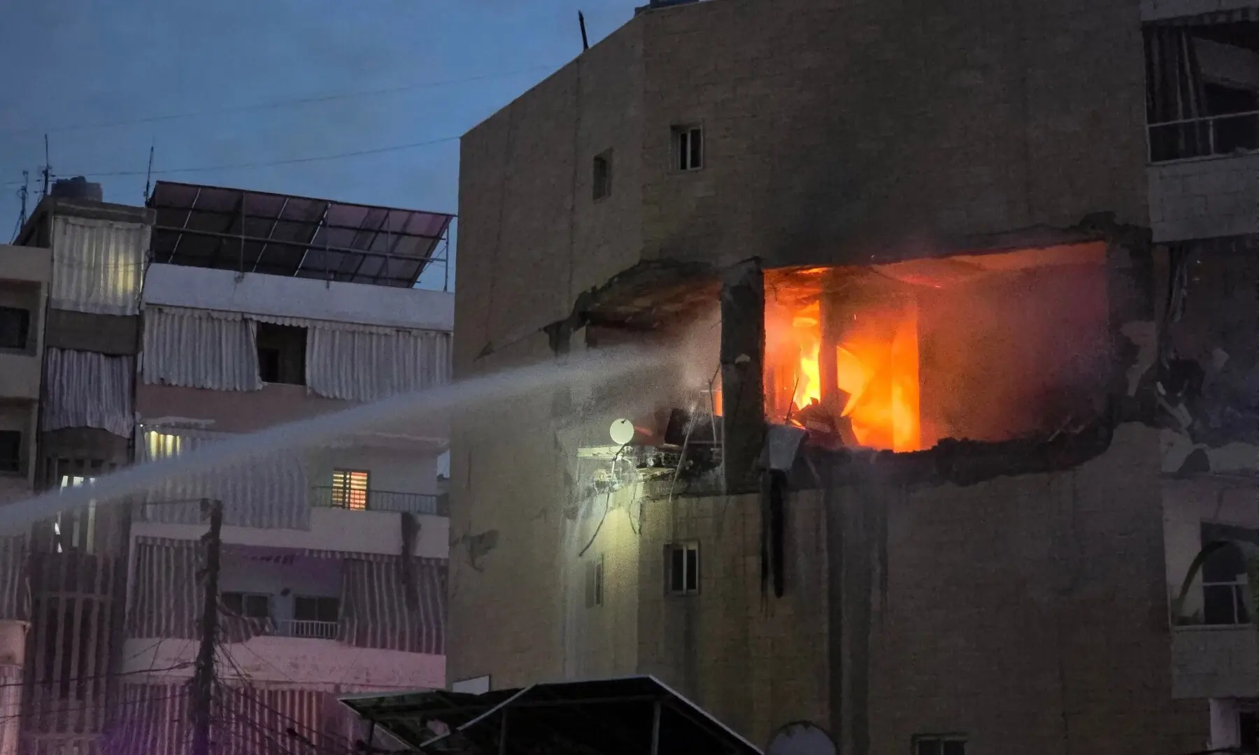 Fire erupts in a building targeted by an Israeli airstrike in the southern Lebanese coastal city of Tyre on March 11. &mdash; AFP