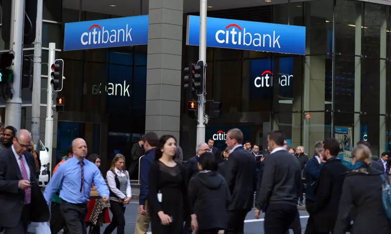  In this File photo People walk in front of a branch of CitiBank in the city&rsquo;s central business district.&mdash;AFP/File 