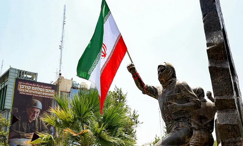 An Iranian national flag is fixed to the arm of a statue at the monument dedicated to the Palestinian struggle in Palestine Square in central Tehran, Iran, July 8.  &mdash; AFP/File