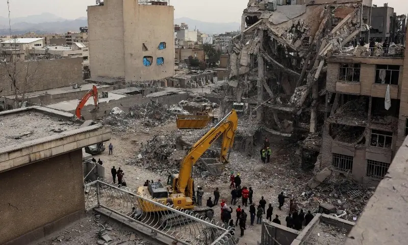 Rescue workers search the rubble of a destroyed residential building in Tehran on March 12. &mdash; AFP